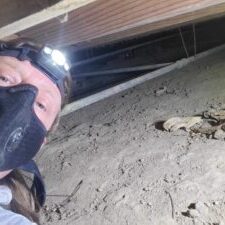 C.W. Home Inspections in a crawlspace.